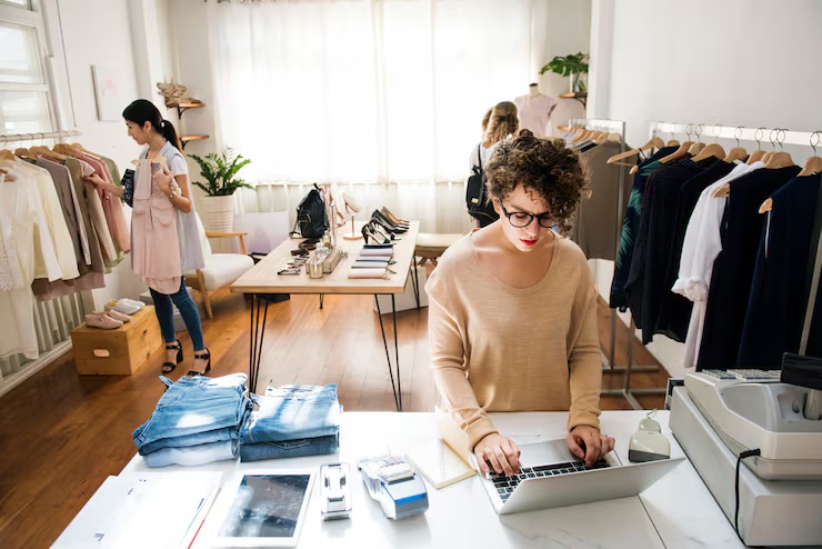 Small business owner working on a laptop in her shop